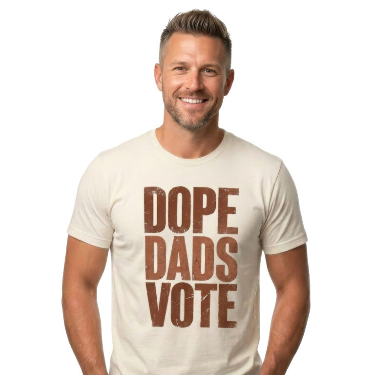 Man wearing a shirt with a close-up graphic design featuring the words DOPE DADS VOTE in tall, bold, terracotta-colored block lettering with heavy distress and cracked texture against a black background.