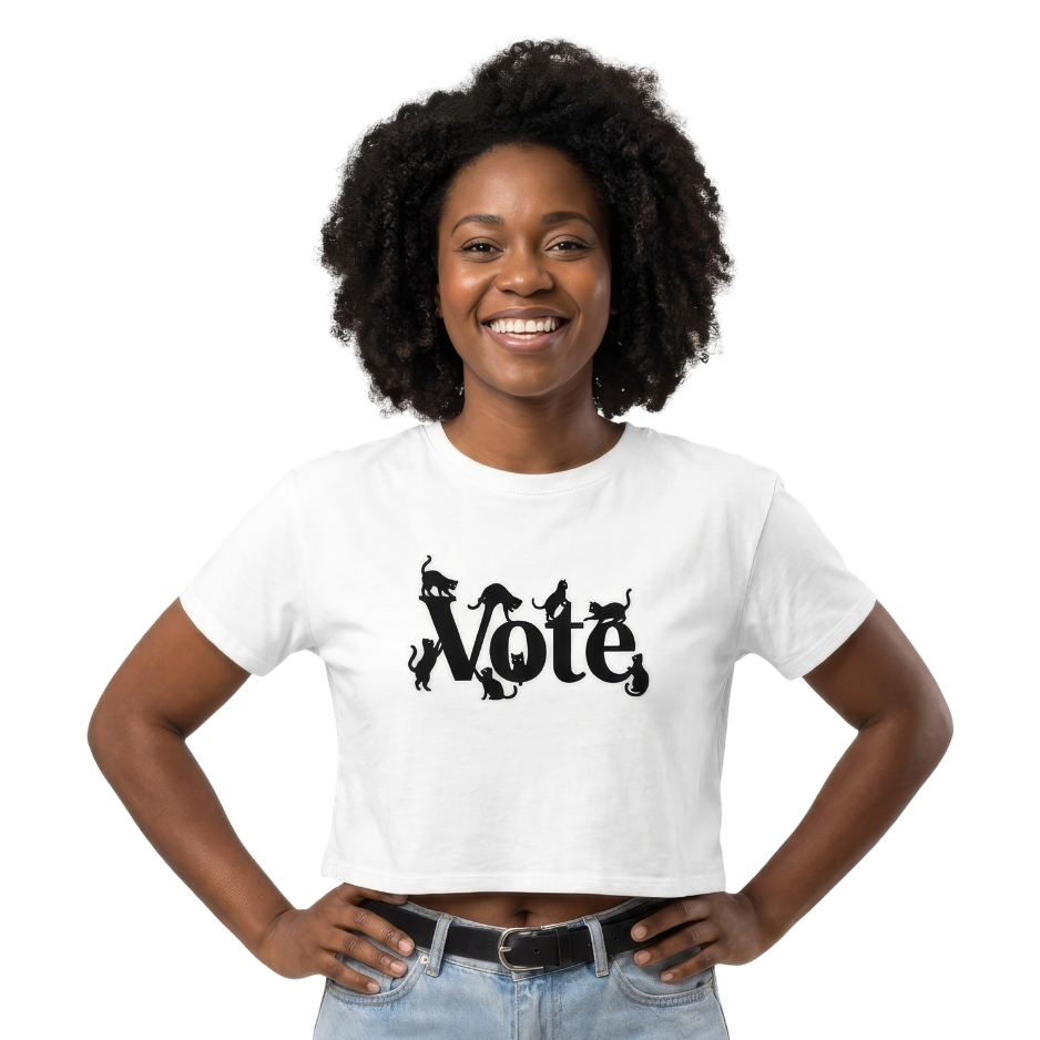 Woman wearing black graphic typography reading VOTE with black cat silhouettes climbing, stretching, and perching on the letters on a transparent background.