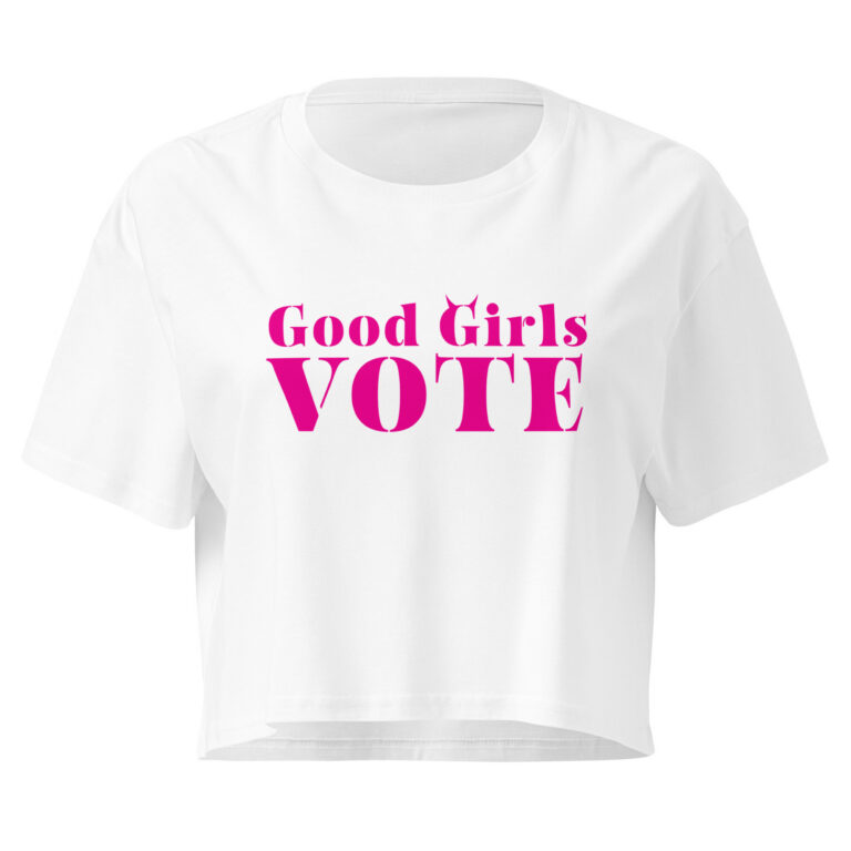White crop tee with bratty pink Good Girls Vote stencil lettering and tiny devil horns on the G, laid flat